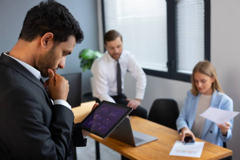 HR professionals analyzing workforce data on a digital tablet during a business meeting